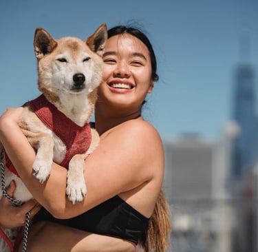 A woman cuddling her dog