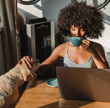 woman sitting with her dog and reading about why professional grooming is essential for pets in Duba