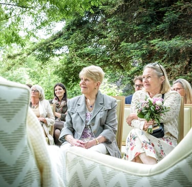 a bride and groomsmen are sitting in a chair