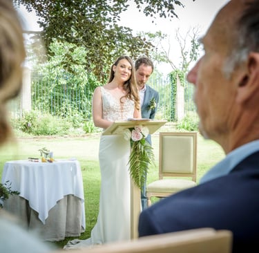 a man and woman standing in front of a table