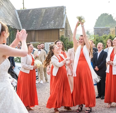 a bride and groomsmid are standing in front of a group of people
