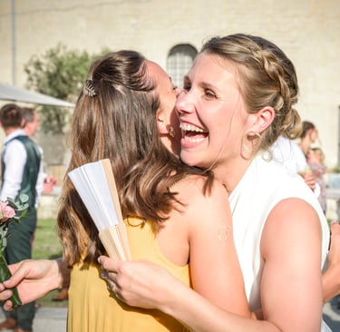 a woman in a yellow dress is hugging her friend