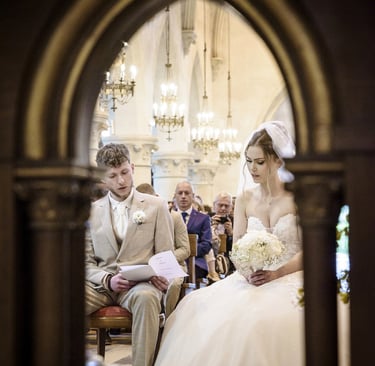 a bride and groom are sitting in a church