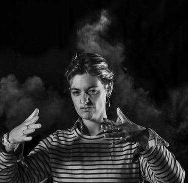 a man in striped shirt holding a cigarette