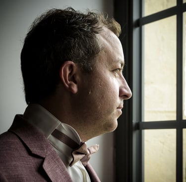a man in a suit and bow tie
