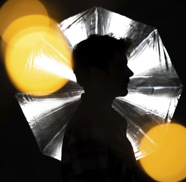 a person holding a umbrella in the dark