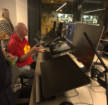 a man sitting at a desk with a laptop computer