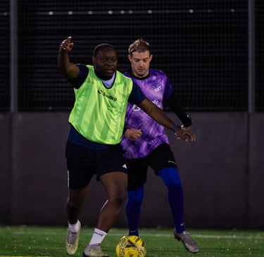 two men playing soccer on a field