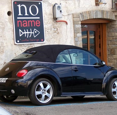 volks wagon infront of no name business name gen implication board