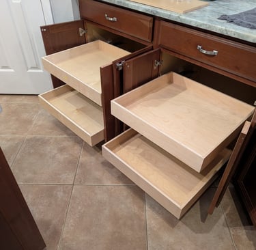 Four pull out shelves extending from two kitchen cabinets, showing excellent storage possibilities.