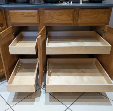 Sliding drawers for cabinets in a kitchen. 