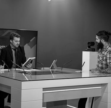 a man in a suit and tie is LMtv Sarthe Aurélien Cailloce itting at a desk with a laptop