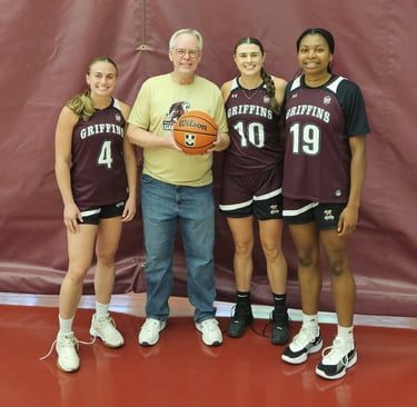 Picture of Allan with Paige, Sofia, and Unity from the MacEwan University Women's Basketball team.