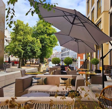 a patio with a couch and umbrella umbrella