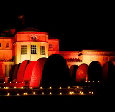 Luminate Shugborough  Hall by Night illuminated in orage light