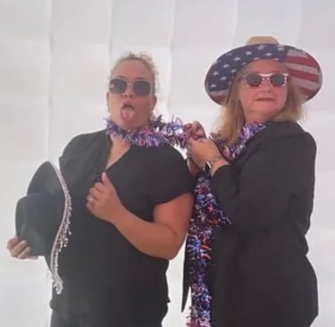 two women in patriotic attire posing for a photo
