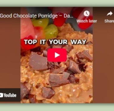 Chocolate porridge with grapes and dark chocolate — a warm, healthy Mediterranean breakfast.