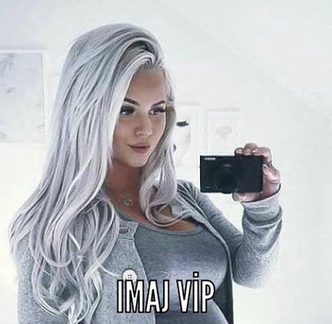 a woman with long hair and a camera taking a selfie