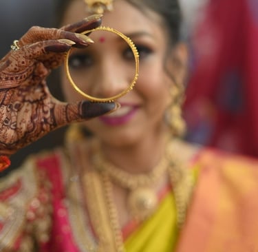 Kerala bride showing her bangle during her bridal makeup session