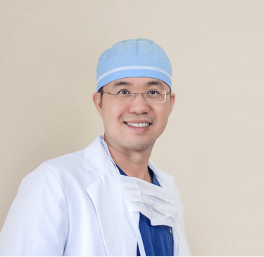 a man in a white lab coat and a blue hat