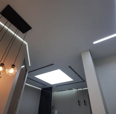 a bathroom with a skylight and a skylight fixture