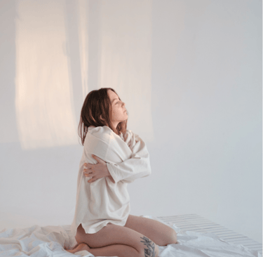 a girl folding her hands around her body