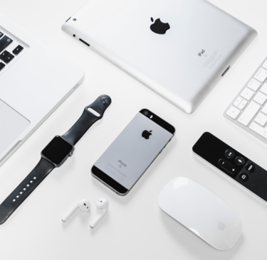 an apple  products on the table watch ,phone,i pods,etc