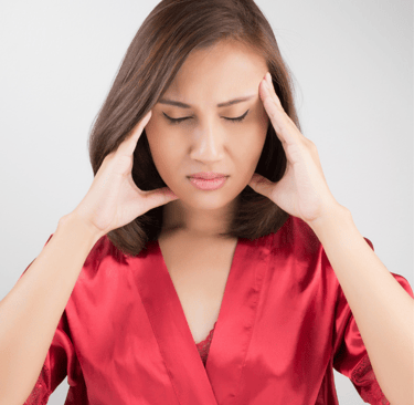 a women  holding her head 