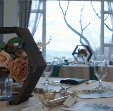 Color graded picture of a table with a vase of flowers and wine glasses