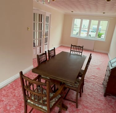 a dining room with freshly painted walls and chandelier