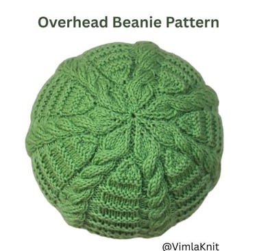 Top view of a green knitted cable beanie, showing the crown shaping and intertwined cable patterns.