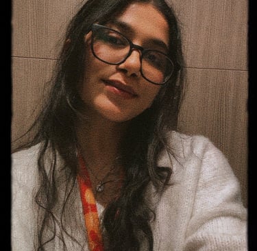 a woman with glasses and a tie around her neck