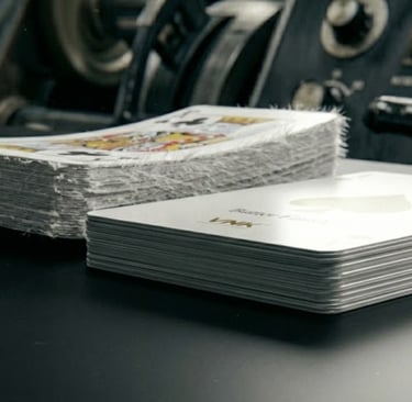 Flat playing card vs warped card demonstrating grain direction importance