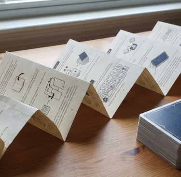 Accordion fold rulebook paper for micro card games.