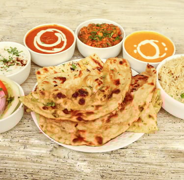 Traditional Indian thali with curry, rice, naan, and flavorful spices