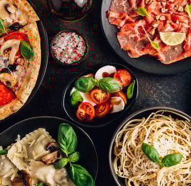 An appetizing spread of classic Italian cuisine, featuring a steaming plate of pasta with rich tomat