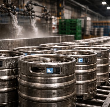 Cleaned stainless steel kegs drying on racks after return in an industrial facility.