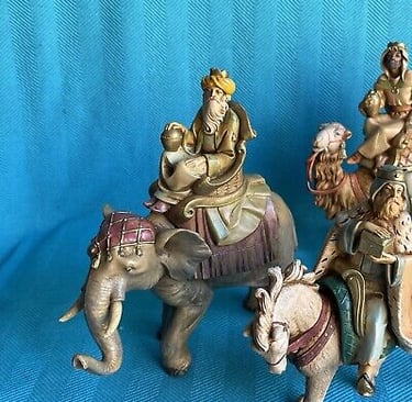 Wise Men riding an elephant, a camel, and a horse