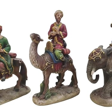 Three Wise Men riding a horse, a camel, and an elephant