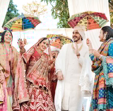 a bride and groomsmid are standing in front of a white tent