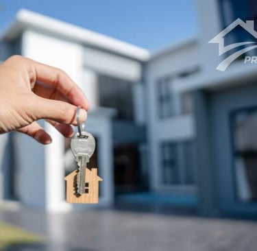 keys and a house in background