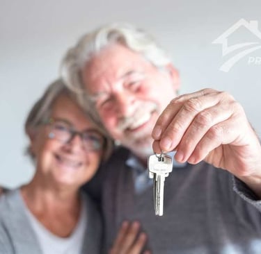 happy older couple keys in hand