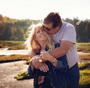 a man and woman embracing in a field