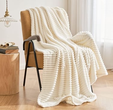 a chair with a blanket on it and a throw blanket