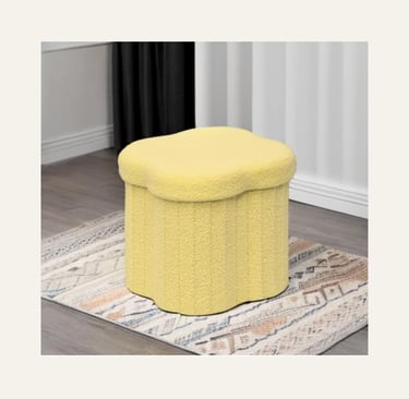 Yellow scalloped storage ottoman in textured sherpa fabric on a patterned rug in a modern living room.