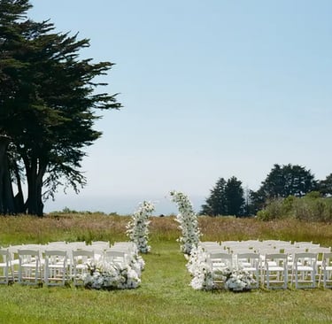 Wedding ceremony on lawn overlooking pacific ocean in Mendocino County