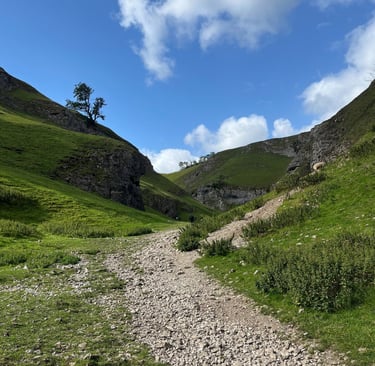 Mentoring in nature. Image of the peak district, rolling green hills and a rocky winding path.
