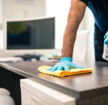 Man cleaning office desk