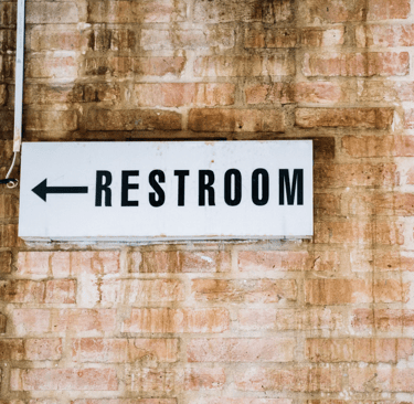 directional restroom sign