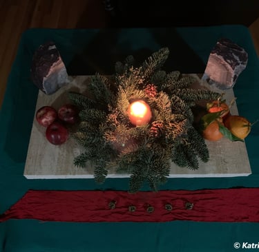 evergreen wreath on marble altar with lighted candle in the center